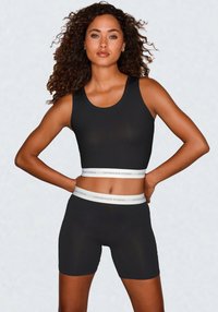 Black athletic tank top and shorts set featuring a smooth texture, fitted design, and contrasting white waistband with "COPENHAGEN STUDIOS" text.