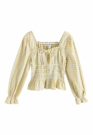 Gul rutmönstrad blus med långa puffärmar, fyrkantig urringning och knytning i detalj. Har en veckad textur och en rynkad fåll.
