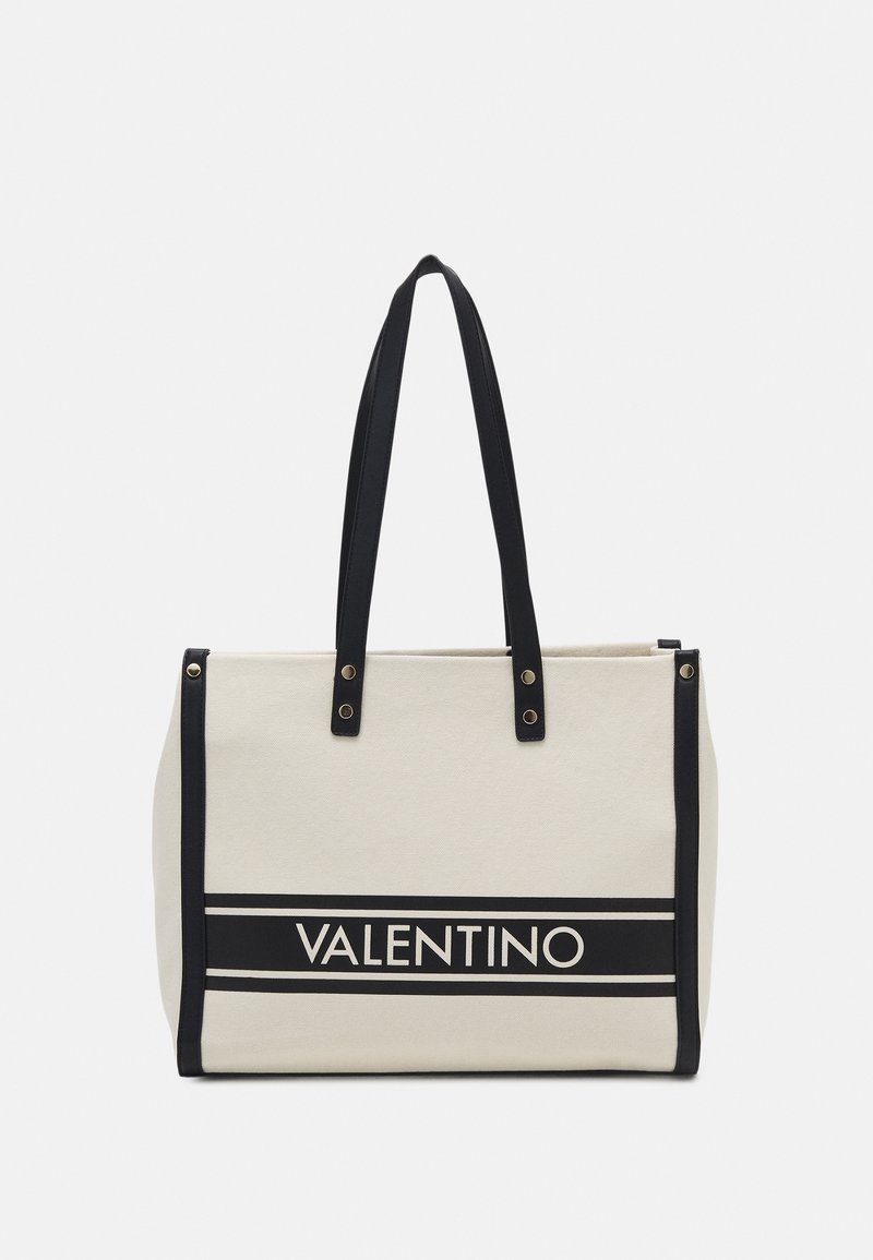 Canvas tote bag in beige with black leather accents, featuring the “VALENTINO” logo and two sturdy black straps for carrying.