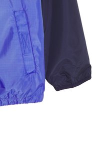 Purple and navy windbreaker jacket featuring a smooth texture, elastic cuffs, and a stitched pocket detail on the left sleeve.