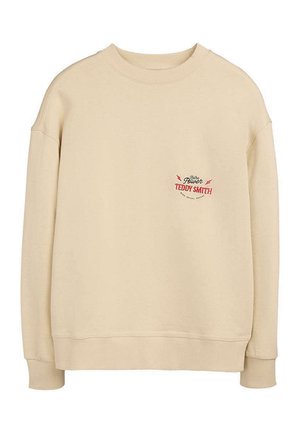 Sweat-shirt beige à manches longues avec col rond et petit texte rouge et noir "Teddy Smith Power" sur la partie gauche de la poitrine.