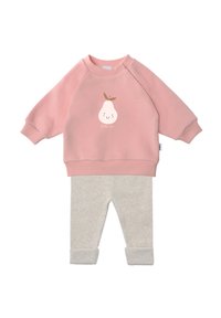 Pink sweatshirt with a pear graphic and text "little one," paired with light gray knit pants featuring rolled cuffs. Soft, casual design.