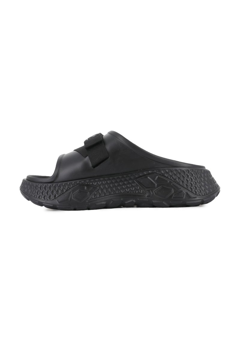 Black slide sandal featuring a textured strap and sole, with a thick, contoured footbed and a rubberized, patterned base for traction.