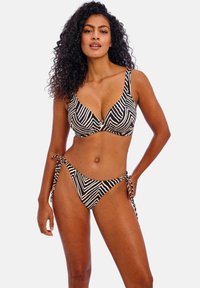 Black and white striped bikini set featuring a padded bralette top and tie-side bottom, accentuated with decorative hardware.