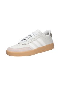 White leather sneakers with light gray accents, three horizontal stripes, and a tan rubber sole. Features lace-up closure and perforated toe.