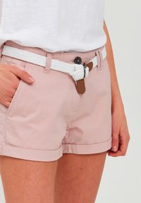 Lyse rosa shorts med et vevd hvitt belte med brune detaljer og knappelukking, med oppbrettede kanter og sidelommer.