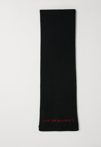 Black ribbed scarf in a long rectangular shape, featuring red embroidered text "RUSLAN BAGINSKY" at one end. Smooth texture.