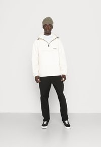 Carhartt WIP Corta-vento - beige