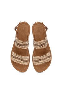 Brown sandals with woven accents in beige and metallic threads, featuring an open-toe design and ankle strap for secure fit.