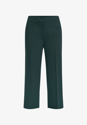 Pantalons larges verts en tissu lisse. Dotés d'une taille mi-haute et de deux poches avant. Design épuré sans embellissements.
