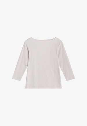 Chemise beige clair à manches longues avec encolure bateau et coupe simple et droite, présentée sur fond blanc.