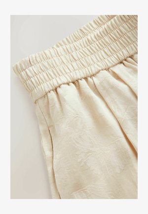 Tessuto beige chiaro con un motivo floreale testurizzato; cintura elastica arricciata; il design a pieghe crea una silhouette morbida e fluida.