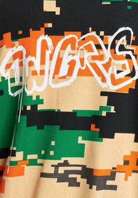 Short-sleeve shirt in multicolor pixelated pattern with black, green, orange, and beige. Features bold white text "ANGRS" on front. Cotton material.
