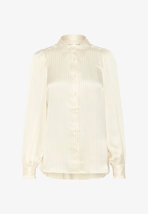 Kreemi värvi, pika varrukaga pluus nööpidega ees, triibuline muster, pehmem tekstuur ja volangkäised. Krae disain ja mugav lõige.