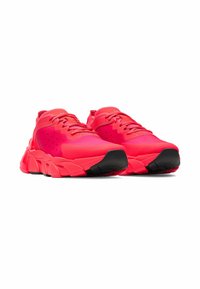 Bright pink athletic shoes with a textured fabric upper, contrasting black rubber sole, and prominent cushioning detailing.