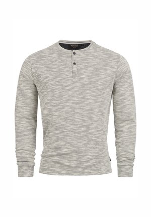 Langermet henley-skjorte i grå med et teksturert, spraglete mønster. Har en hakket krage og en tre-knappers stolpe. Mykt stoff.