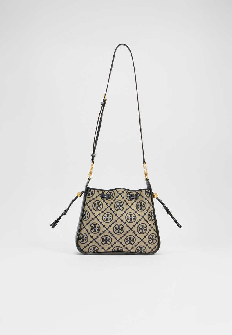 Beige und schwarze gemusterte Bucket-Bag mit Lederbesatz, verstellbarem Gurt und Quastendetail. Verfügt über ein sich wiederholendes Logodesign in einem kunstvollen Muster.