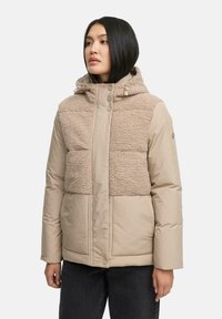 Beige pufferjack met een getextureerde fleece bovenstuk, een glad onderstuk, een capuchon met aanpassingen en een drukknopsluiting.