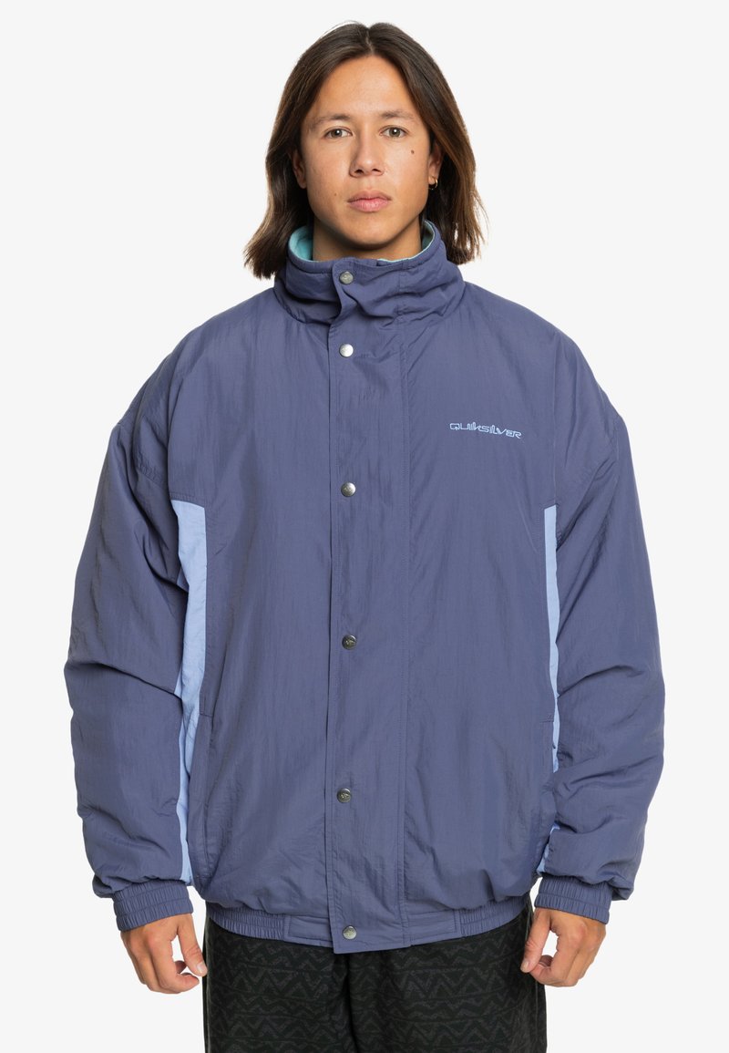Purple insulated jacket with light blue accents, high collar, snap buttons, and elastic cuffs. Features a soft texture and loose fit.