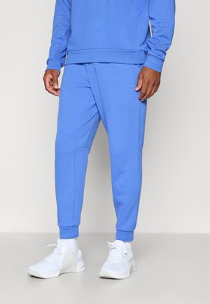 Blue sweatshirt and matching joggers made from soft fabric. Features elastic cuffs, side pockets, and a small logo on the joggers.