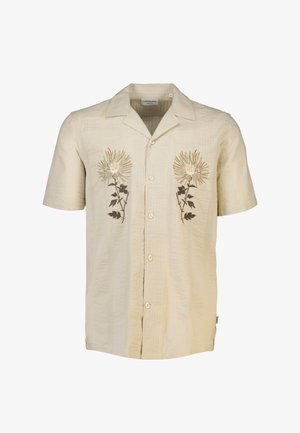 Kortærmet, lys beige skjorte med struktureret stof. Har broderede blomsterdesigns i gul og brun på forsiden, traditionel krave og knaplukning.