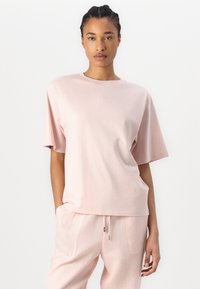 Light pink short-sleeve t-shirt, relaxed fit, round neckline with subtle "BOSS" logo on the chest, soft cotton fabric.