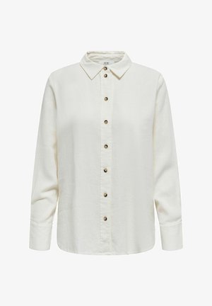 Gai beidžu garām piedurknēm krekls ar apkakles dekoltē, kas piedāvā pogu priekšpusi, noapaļotu malumu un mīkstu audumu ar tekstūru.