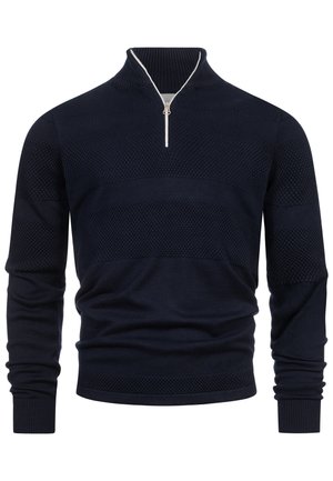 Granatowy sweter dzianinowy o fakturze, z długimi rękawami i srebrnym suwakiem na wysokości ćwiartki, z prążkowanym kołnierzem.