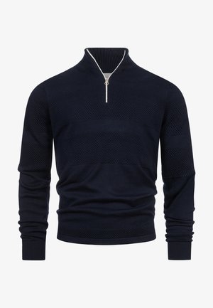 Granatowy sweter dzianinowy o fakturze, z długimi rękawami i srebrnym suwakiem na wysokości ćwiartki, z prążkowanym kołnierzem.