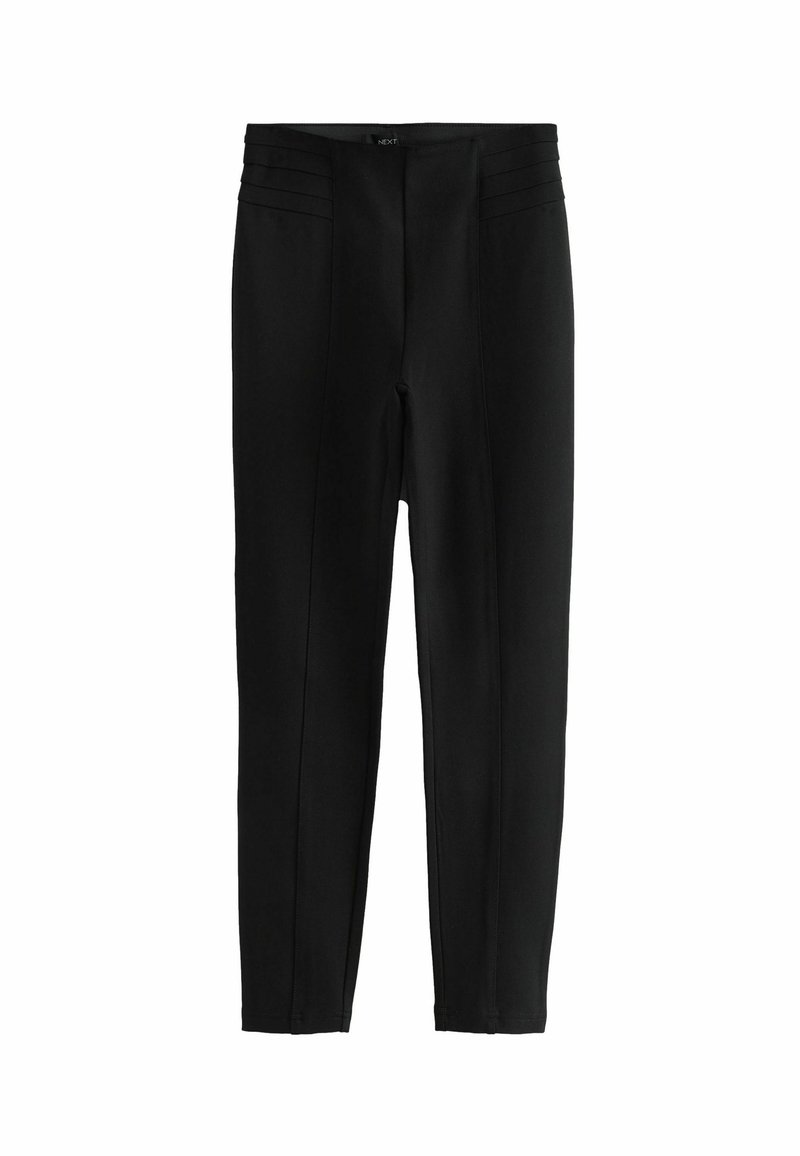 Zwarte leggings met een gladde textuur, voorzien van uitgesproken stikseldetails bij de taille en een aansluitend, taps toelopend ontwerp.