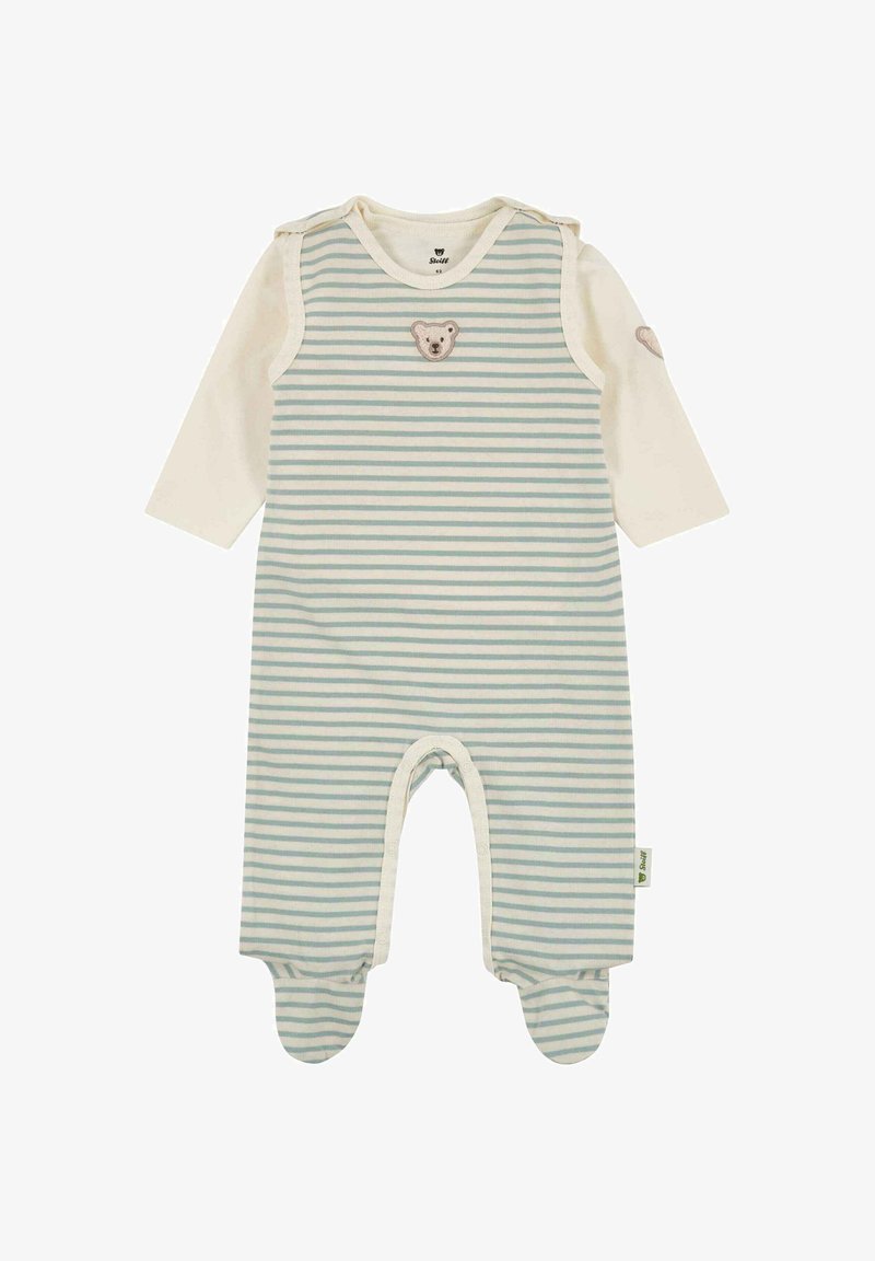 Body bébé à manches longues avec rayures bleues et blanches, jambes avec pieds intégrés, et un petit écusson d'ourson sur la poitrine et la manche.