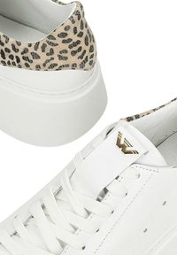 Sneakers in pelle bianca con dettagli a stampa leopardo sul tallone e sul colletto, lacci bianchi, suola spessa e logo in metallo dorato sulla linguetta.