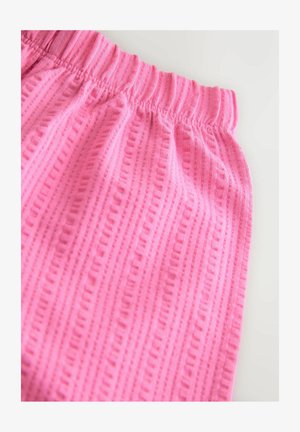 Roosad kangast püksid tekstuurse mustriga, millel on elastne vöökoht ja vertikaalsed triibud. Pehme materjal ja vaba lõige.