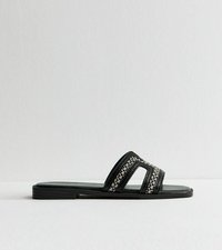 Svart slide-sandal i syntetmaterial med två breda remmar som har ett vävt mönster. Platt sula, minimalistisk design utan synlig hårdvara.