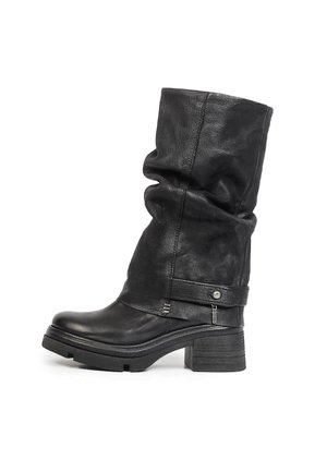 Botte en cuir noire mi-mollet avec un talon épais, une tige texturée et une bride décorative avec une petite fermeture éclair près de la cheville.