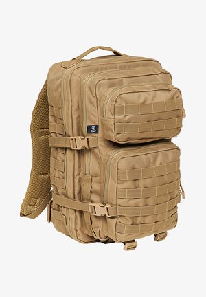 Sac à dos tactique beige avec plusieurs compartiments zippés, coutures renforcées, sangles en sangle pour la fixation d'accessoires et dos en maille rembourré.