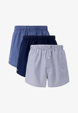Three pairs of boxers in cotton. Features include a blue check pattern, solid navy, and blue stripes with elastic waistbands and small logos.