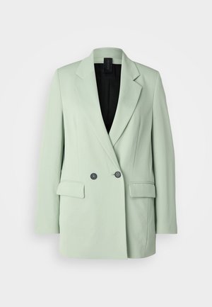Jasnozielony żakiet z podwójnym zapięciem, klapami, dwiema przednimi kieszeniami i czarną podszewką.