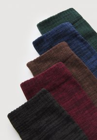 Wool blend socks in black, burgundy, brown, dark blue, and green. Features ribbed texture and varying patterns across colors.