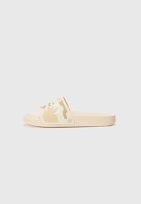 Sandale en slide beige avec une sangle en camouflage texturé et un accent de logo blanc. Matériau en caoutchouc lisse, bout ouvert et design à semelle plate.