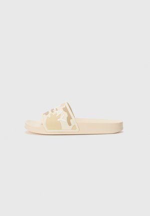 Beige slide sandal with a textured camouflage strap and white logo accent. Smooth rubber material, open toe, and flat sole design.