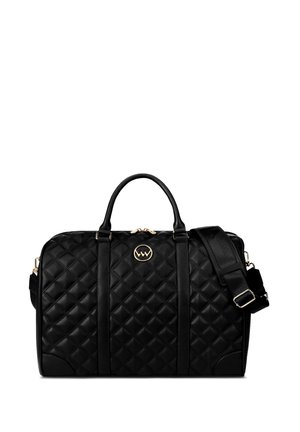 Black quilted leather bag with dual handles, a removable shoulder strap, gold-tone hardware, and a circular logo accent on the front.