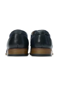Navy leather shoes with a smooth texture, rounded toe, and layered brown heel. Features contrast stitching and perforated accents.