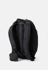Black backpack with padded mesh straps, dual zippered compartments, and a detachable small pouch. Features a sleek, ergonomic design.