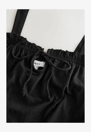 Černý bavlněný top na ramínka s elastickým výstřihem s tkaničkou, volánkovými okraji a štítkem s názvem značky "NEXT."