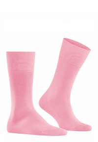 Calzini di cotone rosa con una texture liscia, design a metà polpaccio e polsini a coste. Struttura leggera e senza cuciture per il massimo comfort.