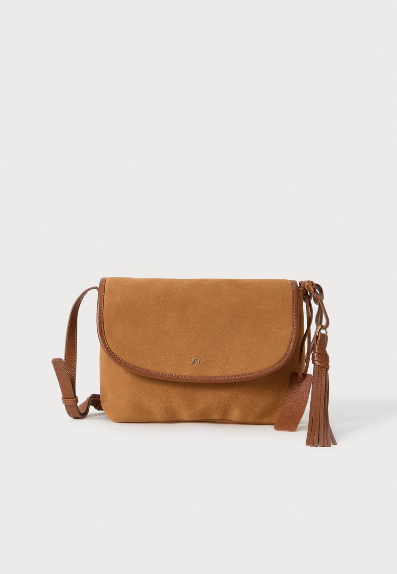 Brown suede crossbody bag with leather trim, flap closure, and a decorative tassel. Features a simple design and adjustable strap.