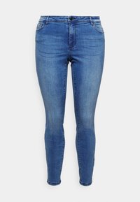 Skinny jeans in medium blue denim, featuring a front button closure, belt loops, five pocket design, and a smooth, slightly faded texture.