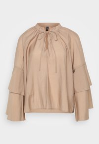 Beige blouse with a round neckline, tie detail, and tiered bell sleeves. Made from a lightweight, smooth fabric with a relaxed fit.