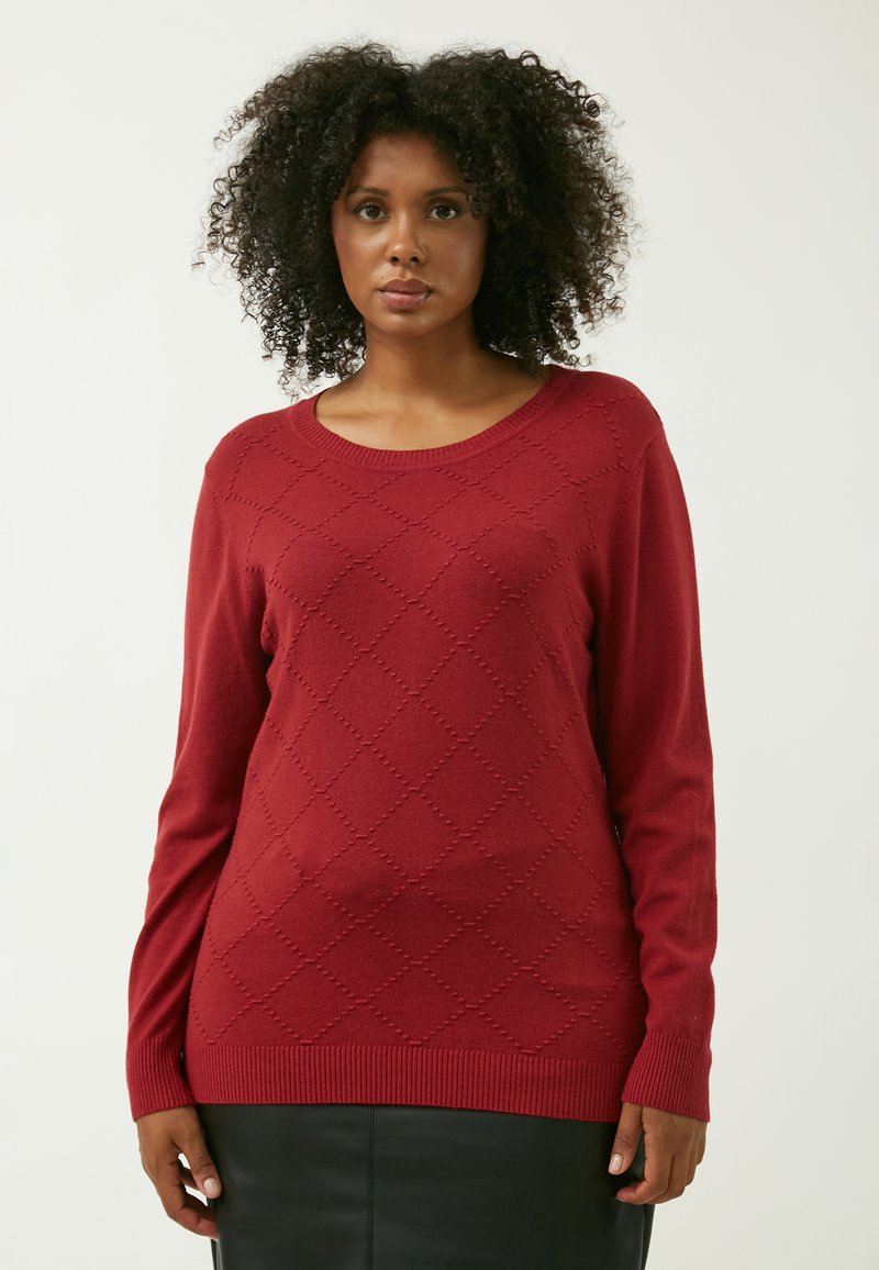 Roter gestrickter Pullover mit langen Ärmeln, rundem Ausschnitt und einem Rautenmuster. Weicher Stoff mit geripptem Saum und Bündchen.